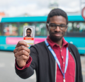 Picture of our student holding their bus pass.