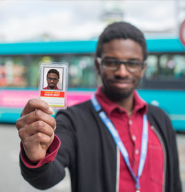 Picture of one of our students holding up his bus pass