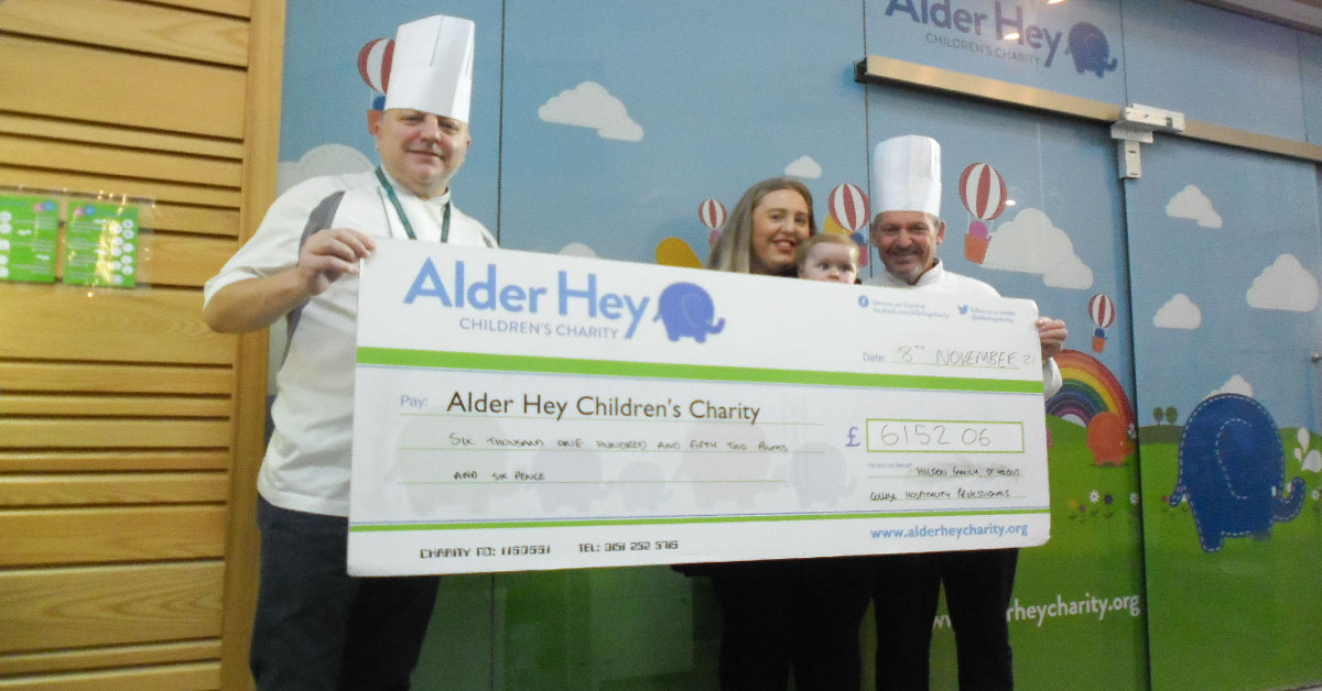Colours Restaurant chef presenting cheque to benefit Alder Hey.