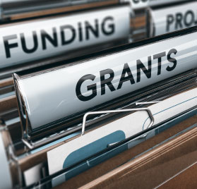 Picture of filing system saying funding and grants