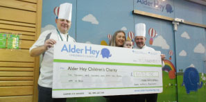 Colours Restaurant chef presenting cheque to benefit Alder Hey.