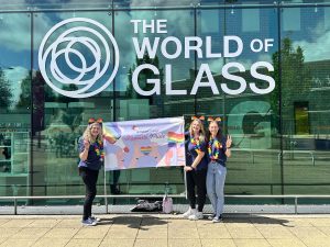 Staff holding pride flag