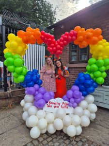 Staff stood in heart balloon arch