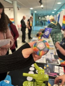 Visitor holding colourful pin badge