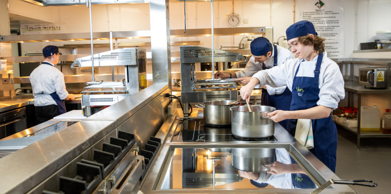Picture of our students working in our new kitchen