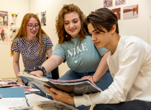 Picture of our student looking through their portfolio