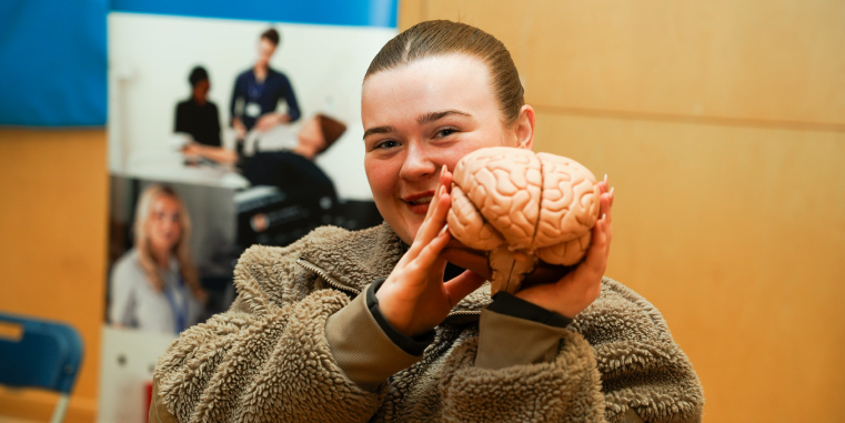 Picture of one of our students holding a fake brain