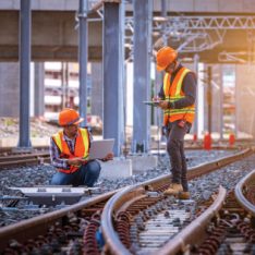 Engineer under inspection and checking construction process rail